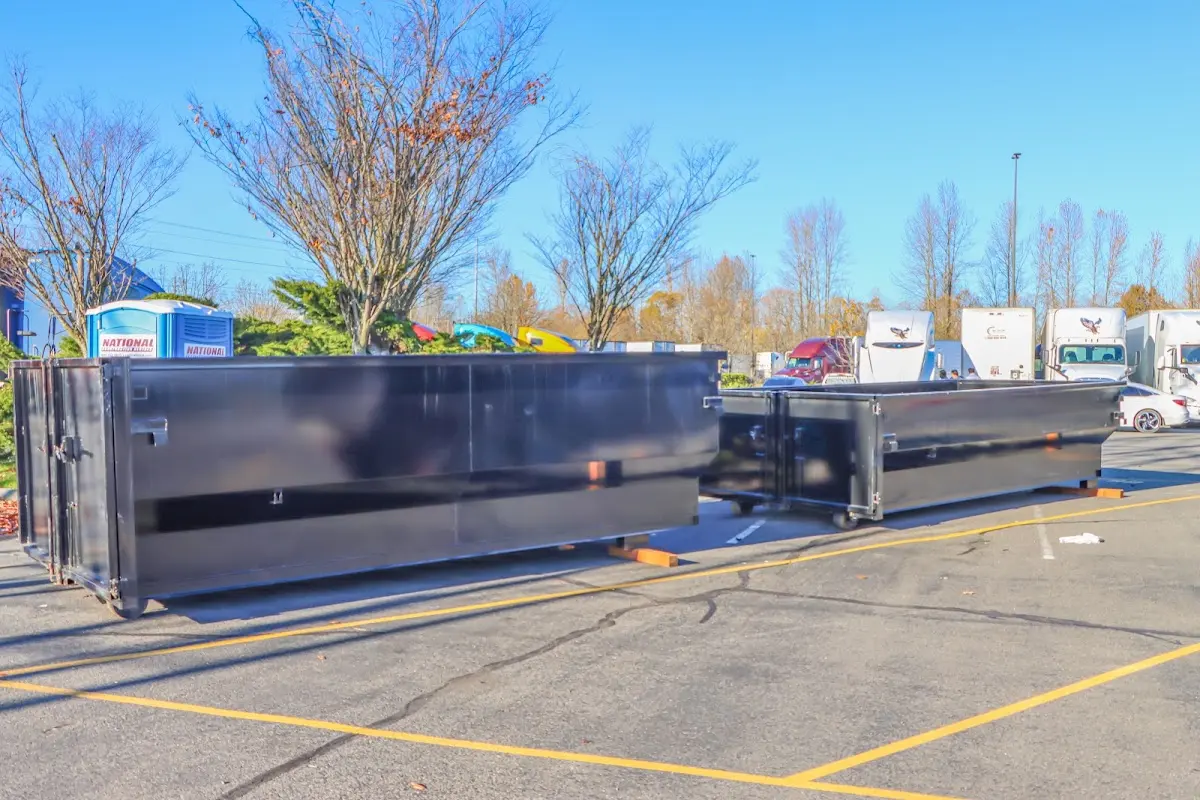 Professional dumpster rental service with roll-off container on residential driveway in Vancouver